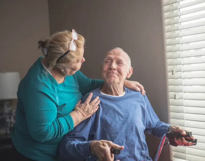 A hospice worker looking at an elderly man in LA or Orange County